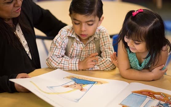 Two children reading while in the UNITED WAY- Parent-Child Home Program