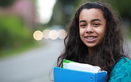 African American girl with school notebook