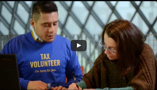 Free Tax Campaign volunteer helping woman do taxes