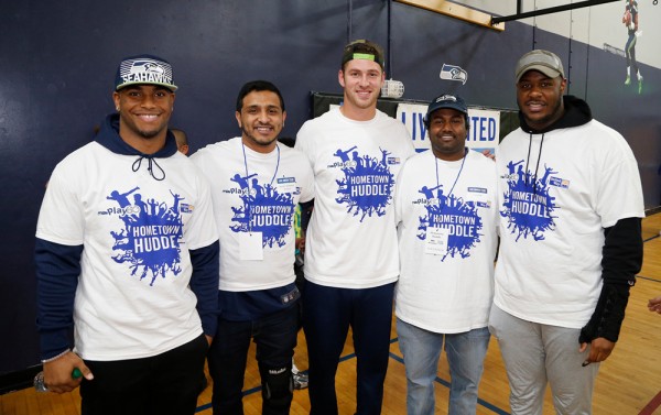 Photo of Hometown Huddle volunteers posing with Seattle Seahawks