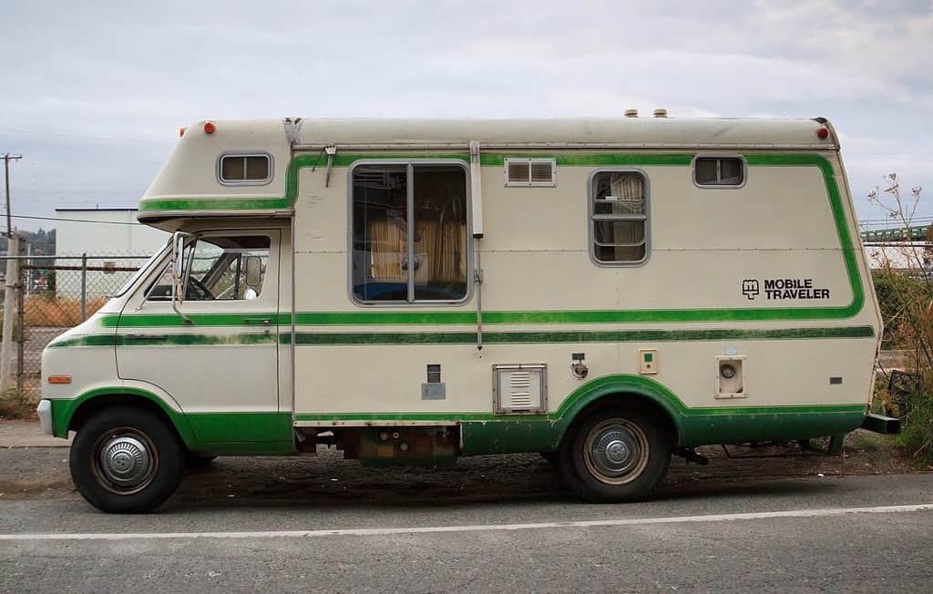 Image of an old RV parked by the side of the road