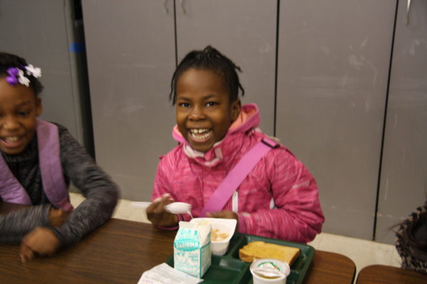 Photo of young student drinking grape juice