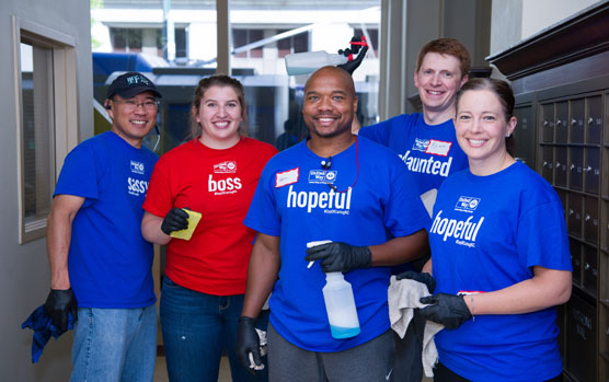 Group of 5 smiling volunteers with cleaning supplies join United Way's Day & Night of Caring Seattle volunteer event