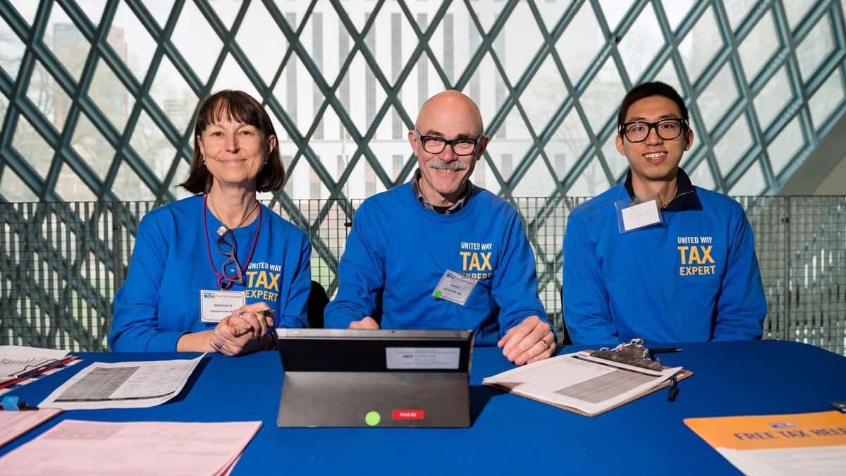 Photo of three Microsoft volunteers at a tax site