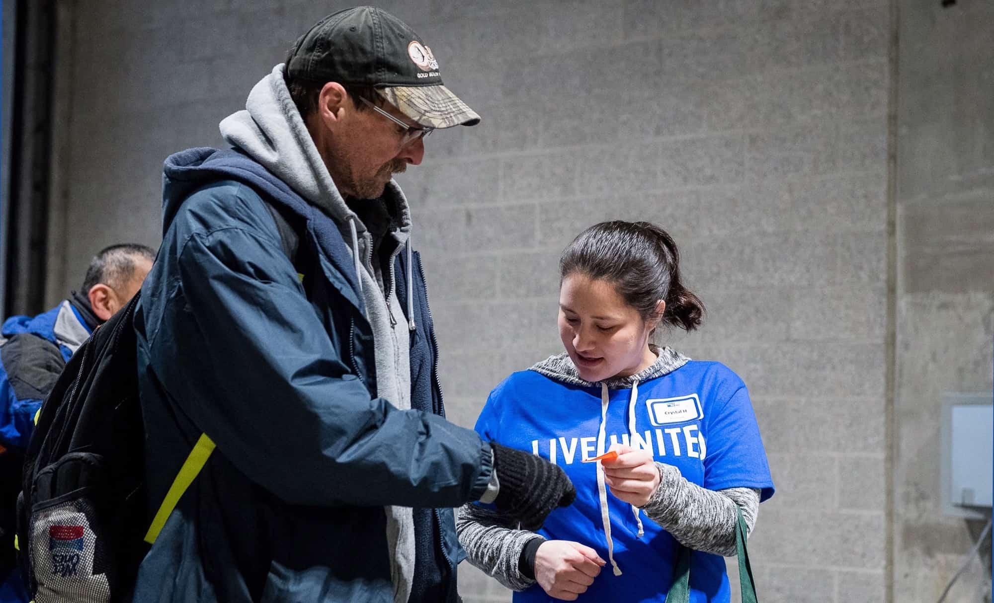 Volunteering helping man struggling with homelessness