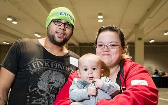 Family homelessness at United Way Resource Exchange - young mom and dad smiling with baby boy