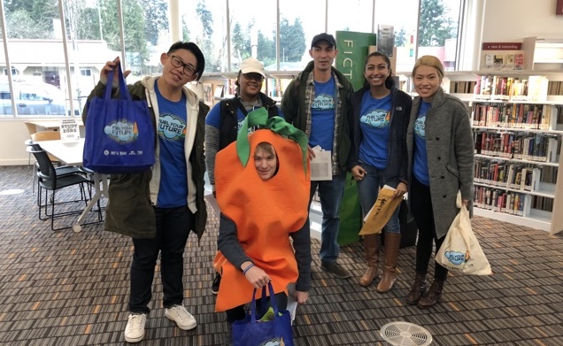 AmeriCorps group standing in a line, with one member in a carrot costume