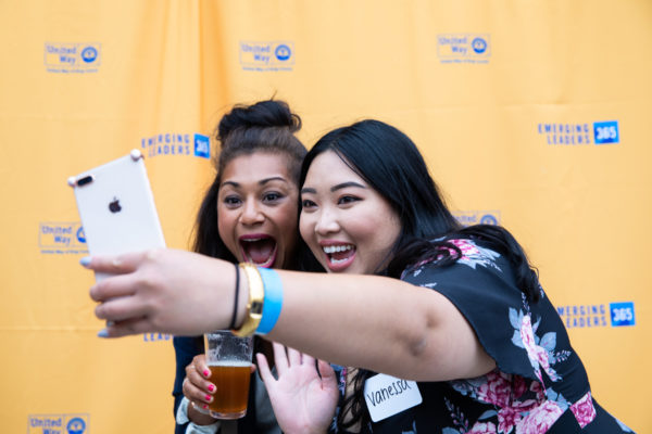 Young professionals group smile with Geekwire's Jonathan Sposato at Peddler Brewing