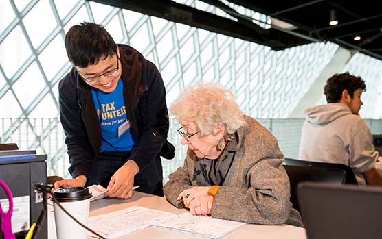 United Way free tax preparation volunteer helps elderly woman