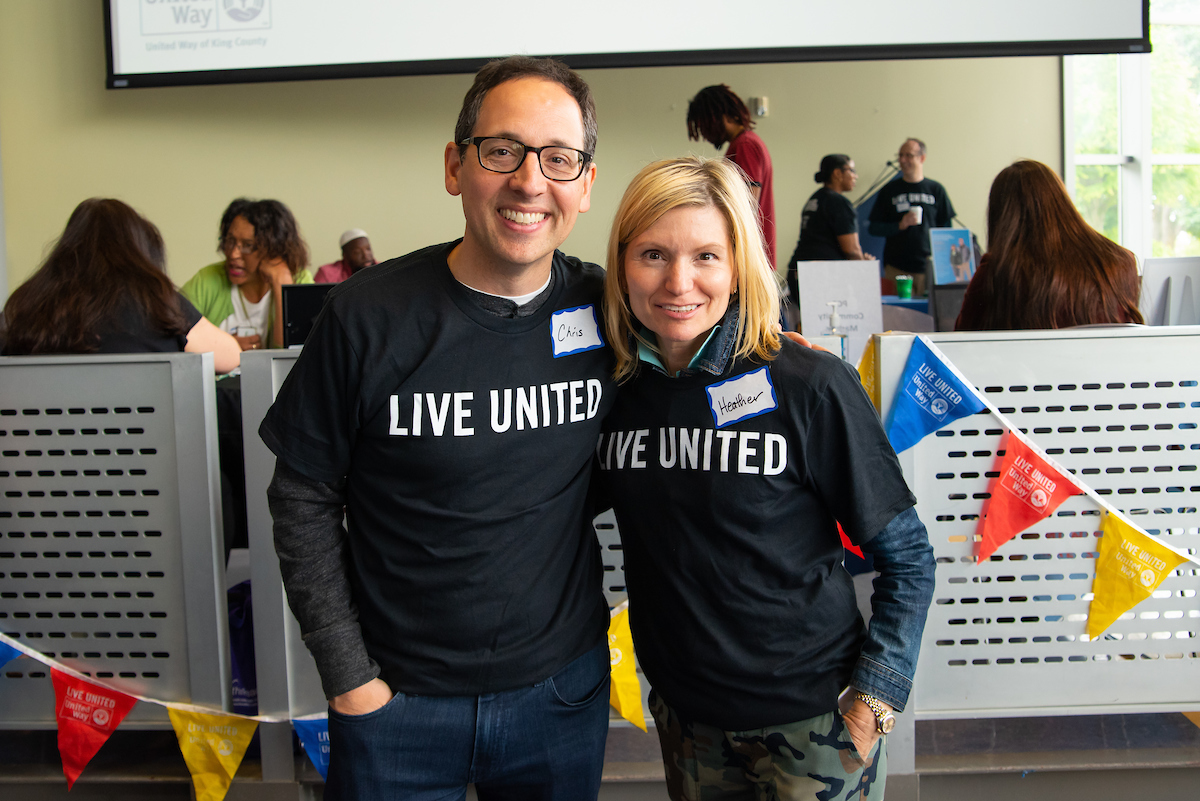 Image of Chris Capossela, Microsoft's chief marketing officer, and Heather Lowenthall, author of this post. They both wear black t-shirts that say 
