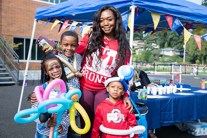 A mother and her three children pose for a photo at the Family Resource Exchange