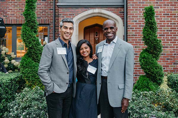 Kabir Shahani, Noreen Shahani and Gordon McHenry, Jr. pose together infront of the Shahani's home entrance.