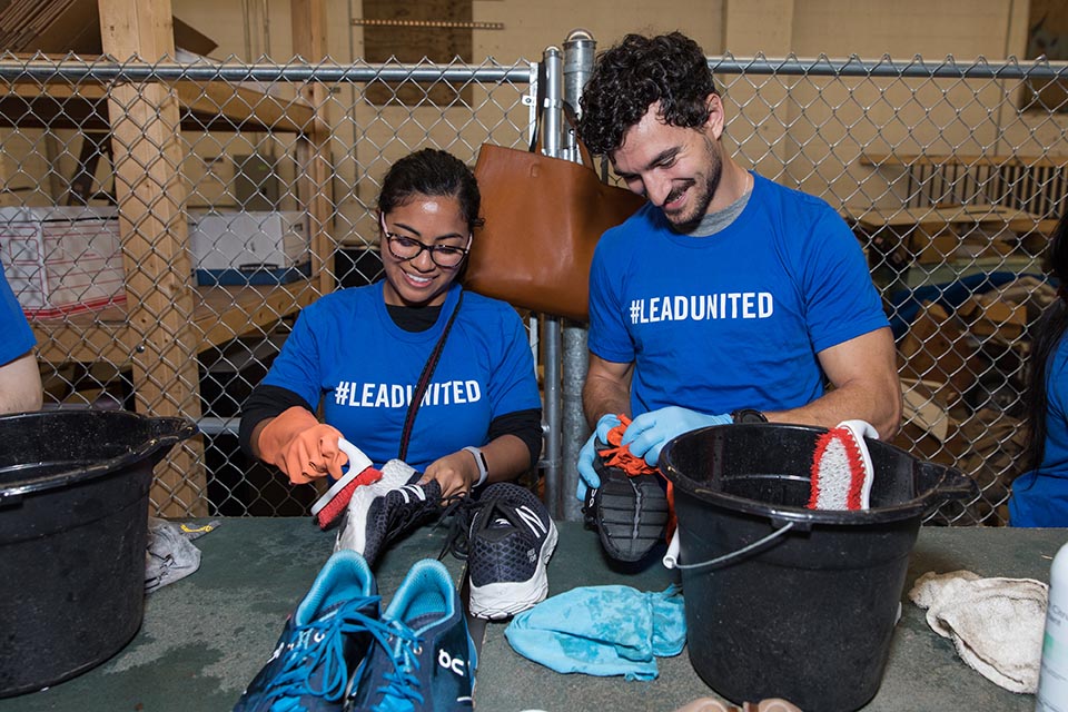 Emerging Leaders washing shoes