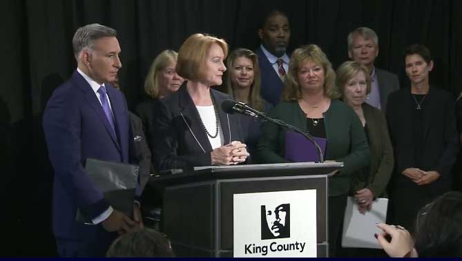 Seattle Mayor Jenny Durkan and King County Executive Dow Constantine stand behind podium while announcing new regional authority to fight homelessness