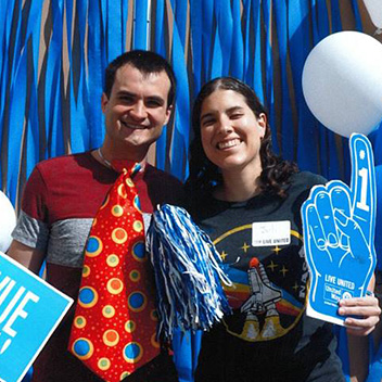 Philip and Juliana stand in front of balloons