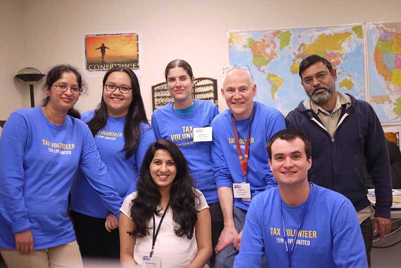 Philip and Juliana pose in a group photo with other tax volunteers