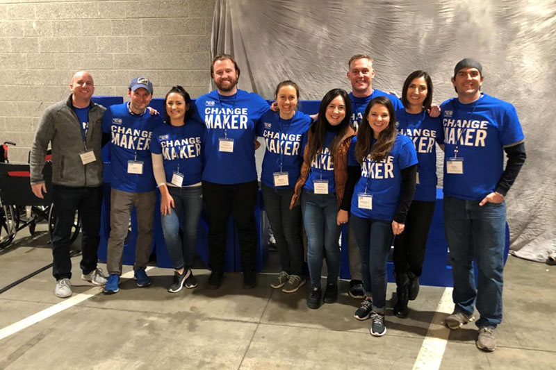 A group of volunteers from Brighton Jones company wearing blue shirts