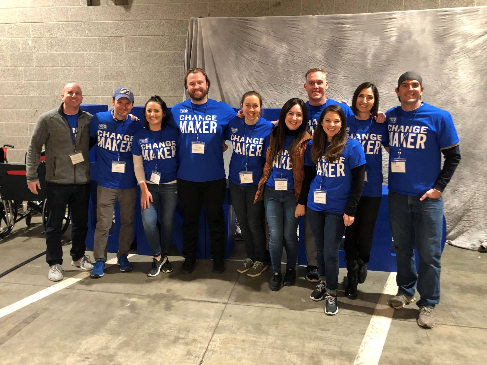 A group of volunteers from Brighton Jones company wearing blue shirts