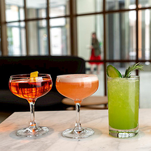 3 cocktails sitting on a table