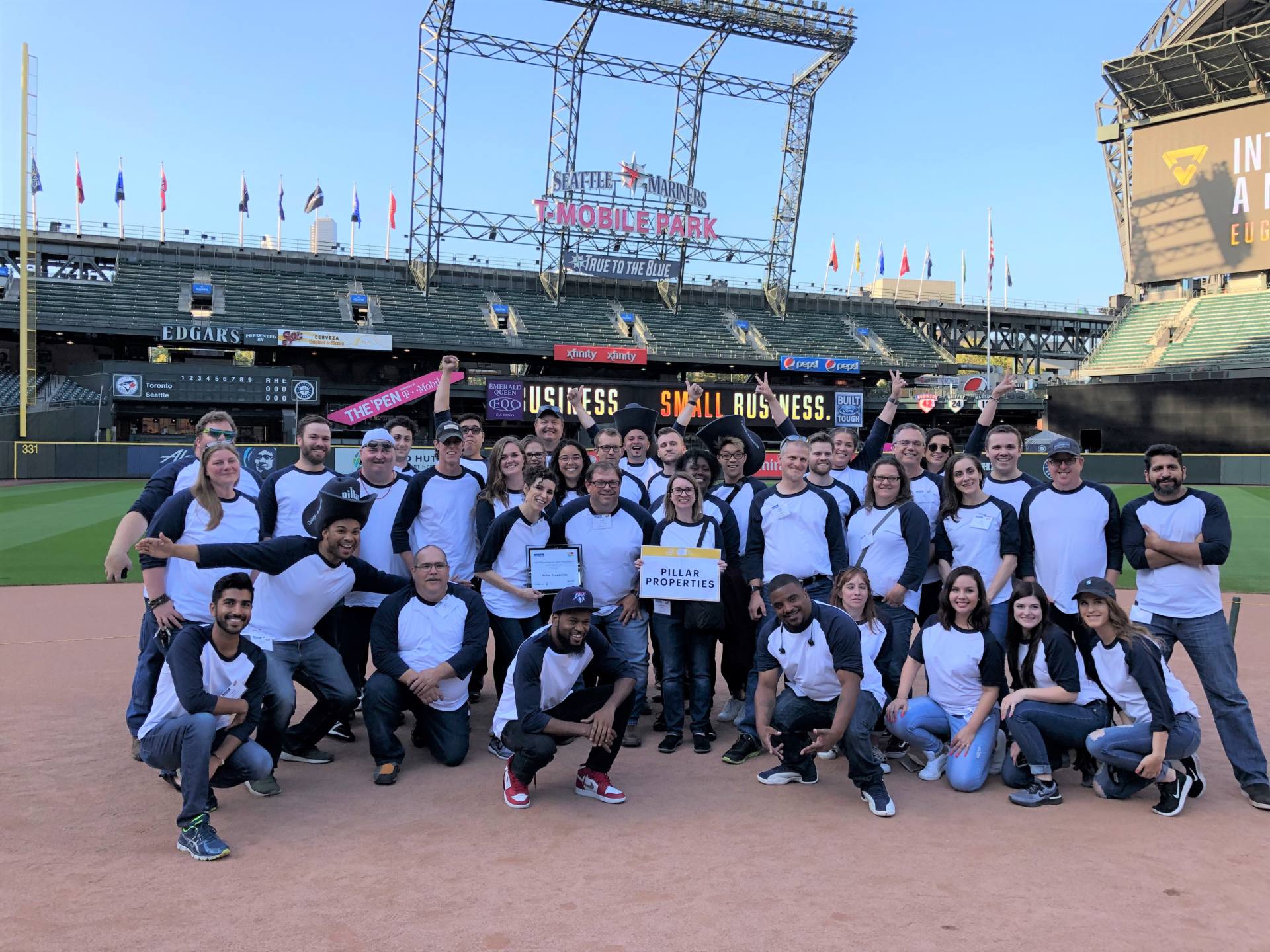 group shot of Pillar properties employess in the field of Seattle Mariners t-mobile part