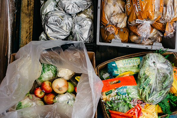 several boxes containing fresh fruits and vegetables and other food.