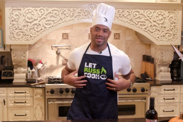 Seahawks' Russell Wilson and two volunteers at event to help feed kids