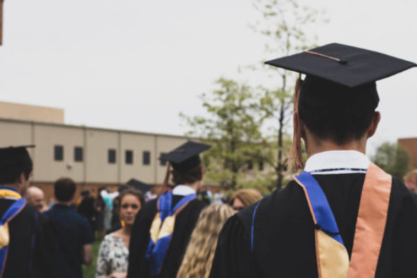 Students wearing cap and gown for high school graduation