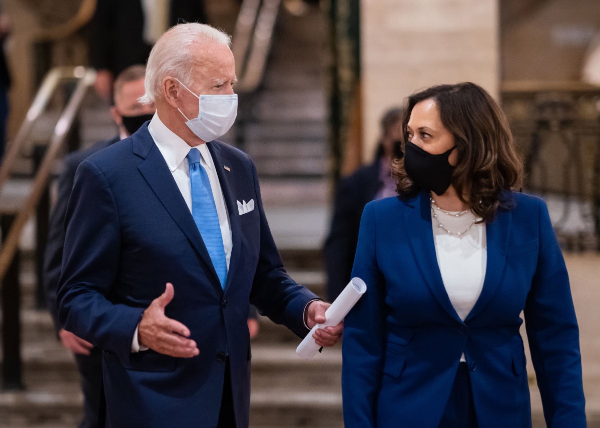 The president and vice president wearing masks and talking to each other