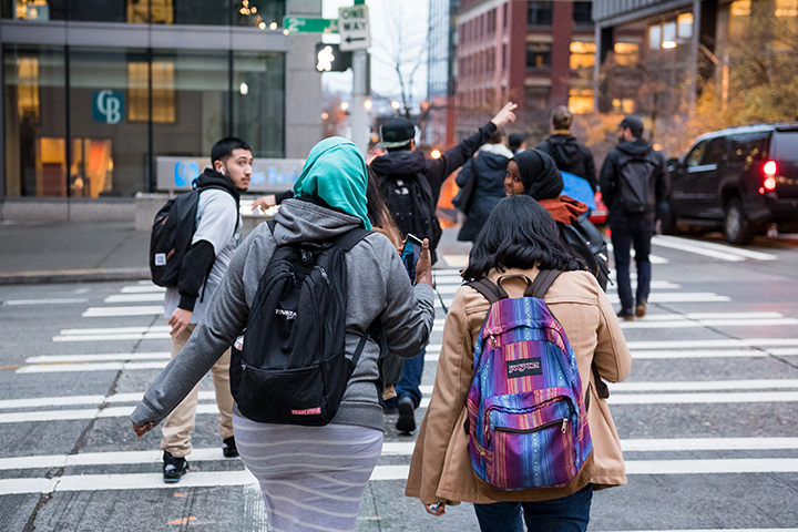 Several students cross the street in downtown seattle
