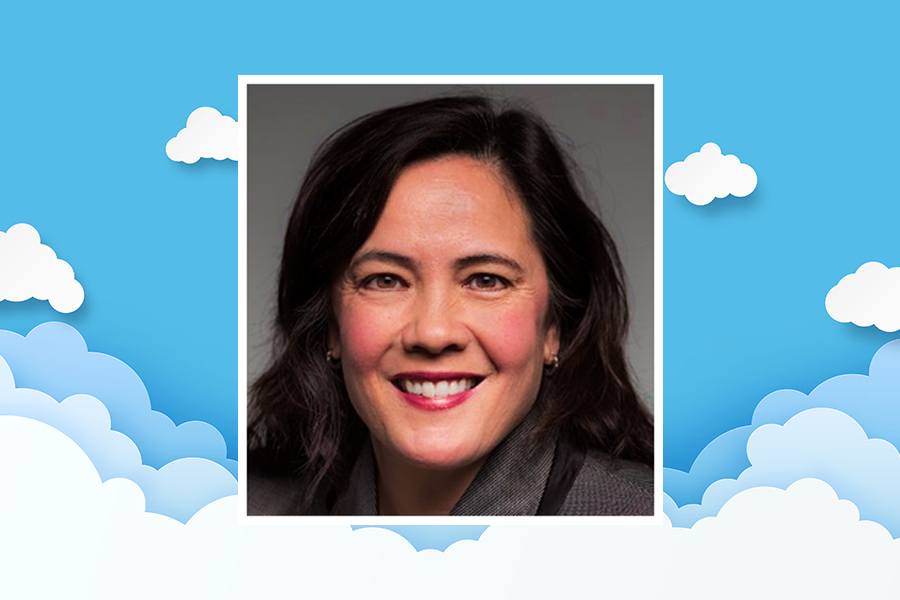 Head shot of Karen Bryant overlaying a background graphic of clouds and blue sky