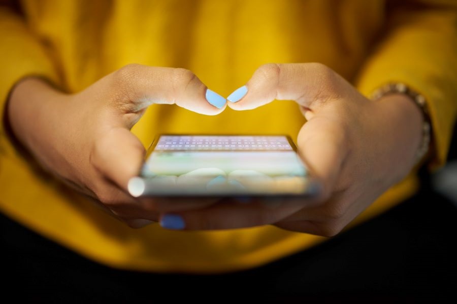 a person texting with a cell phone