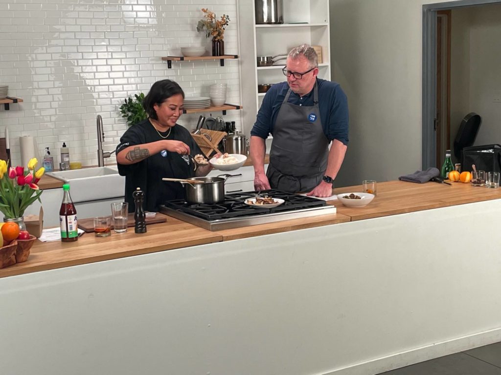 Image of chefs Melissa Miranda and Ethan Stowell in a makeshift kitchen conducting a cooking class