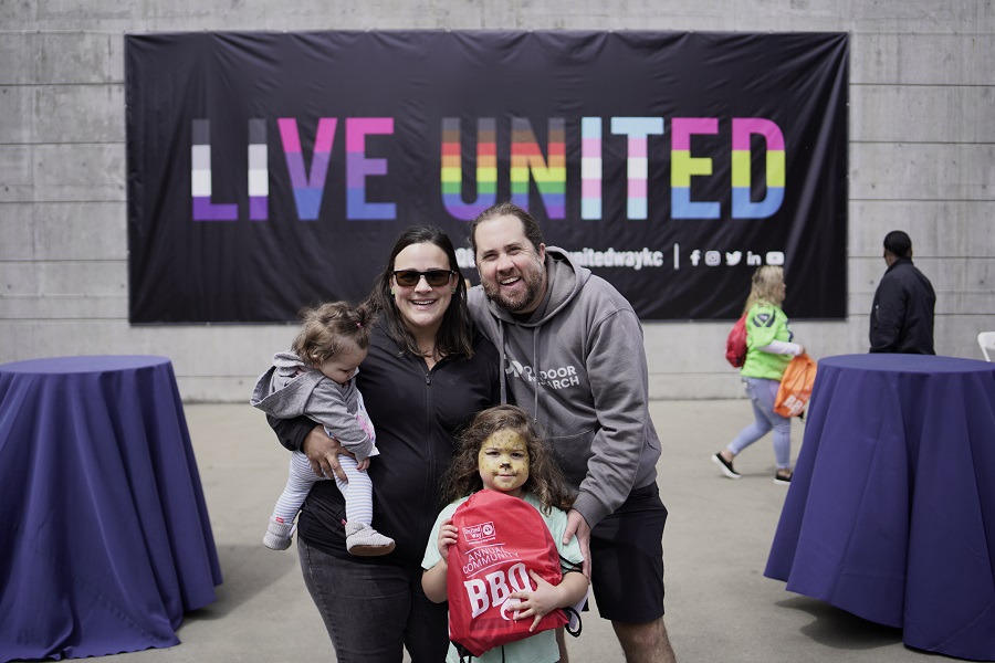 Maher family with the Live United sign in the background at the first Annual Community BBQ