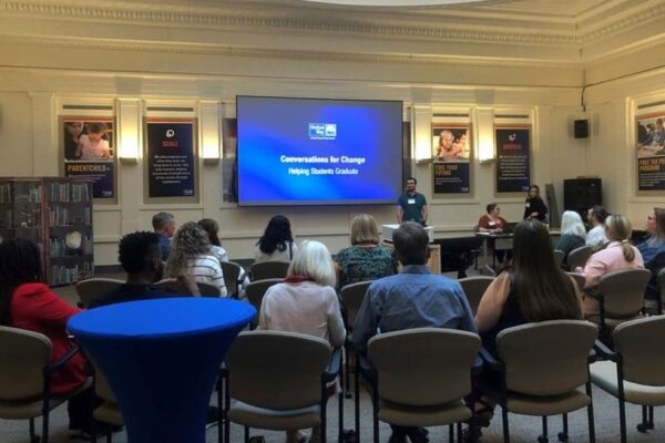 Sara Goldrick-Rab stands in front of a room while giving a talk on college completion rates.