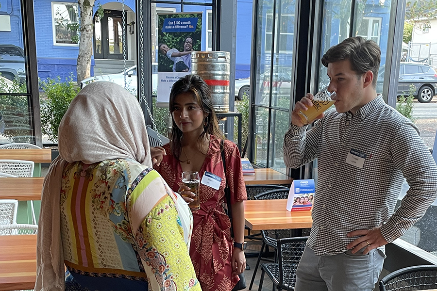 People enjoying conversation and a beer together