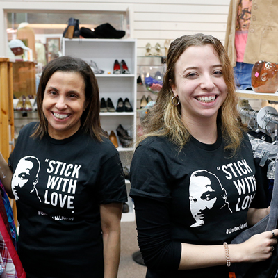 A mother and daughter volunteering wearing MLK Day T-shirts