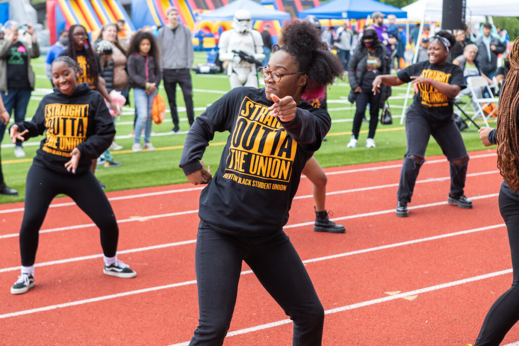 Girls dancing on a track field in uniform