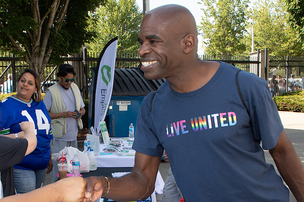 Gordon Mchenry, Jr. shaking hands with a person smiling