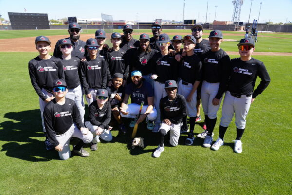 Baseball Beyond Borders founder Bookie Gates outside a gated baseball field
