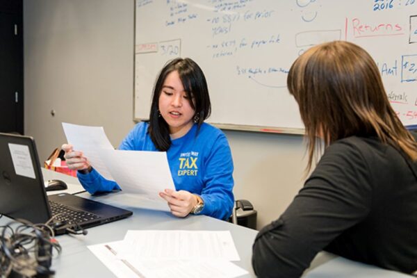 United Way free tax preparation volunteer helps elderly woman