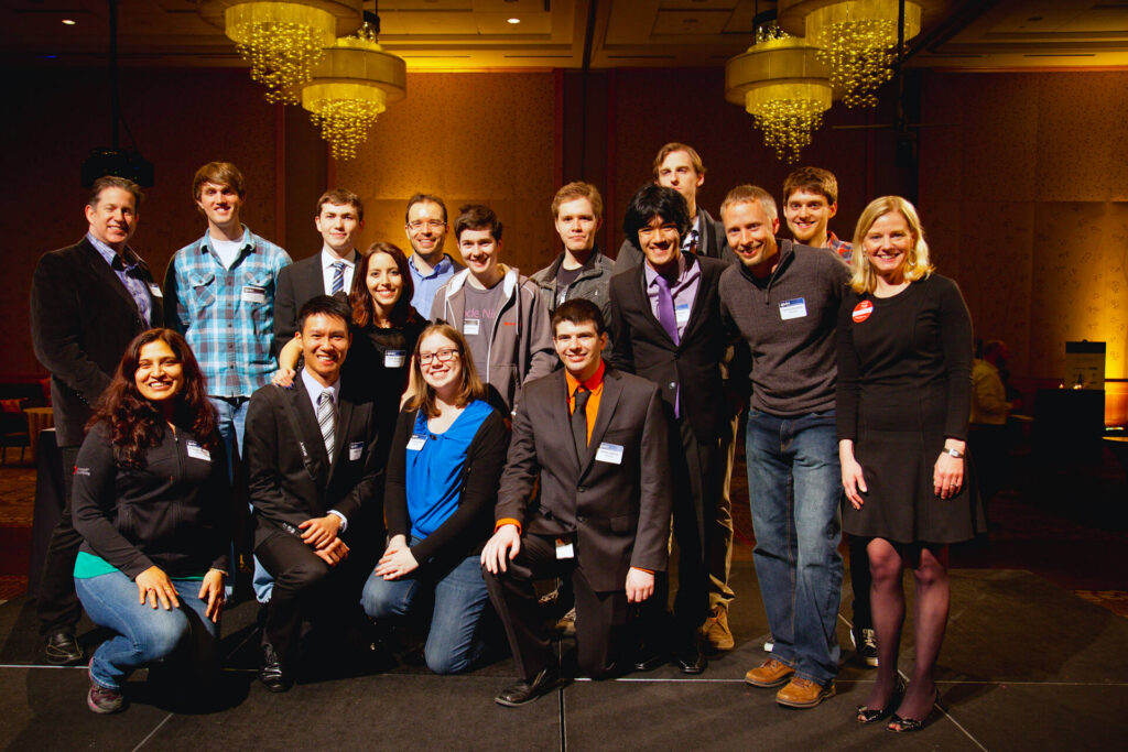Group photo of people gathered at an indoor event.